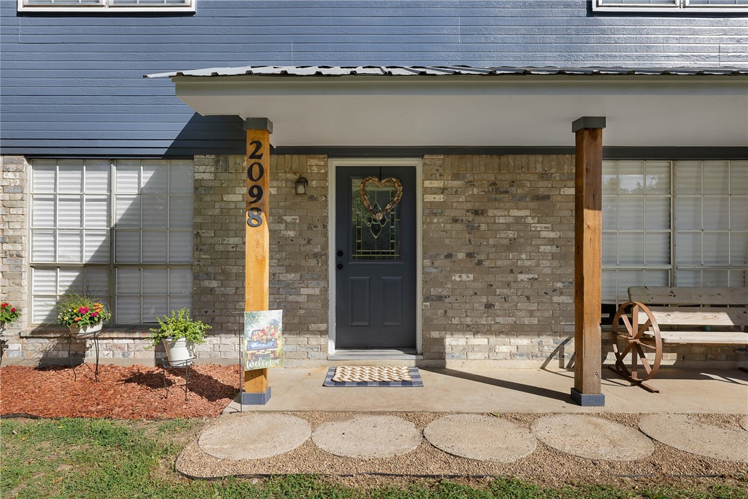 2098 Cedar Creek Road Hearne, TX 77859 - Photo 2 of 18 a front view of a house with outdoor seating