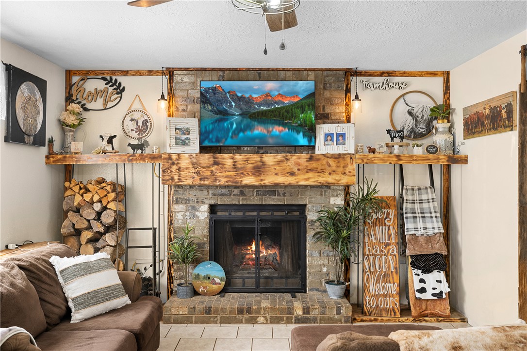 2098 Cedar Creek Road Hearne, TX 77859 - Photo 3 of 18 a living room with furniture a fireplace and wall paintings