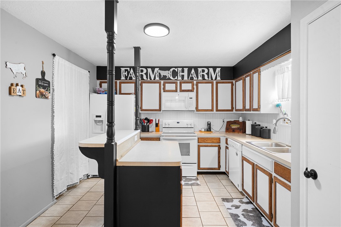 2098 Cedar Creek Road Hearne, TX 77859 - Photo 7 of 18 a kitchen with a refrigerator a sink and cabinets