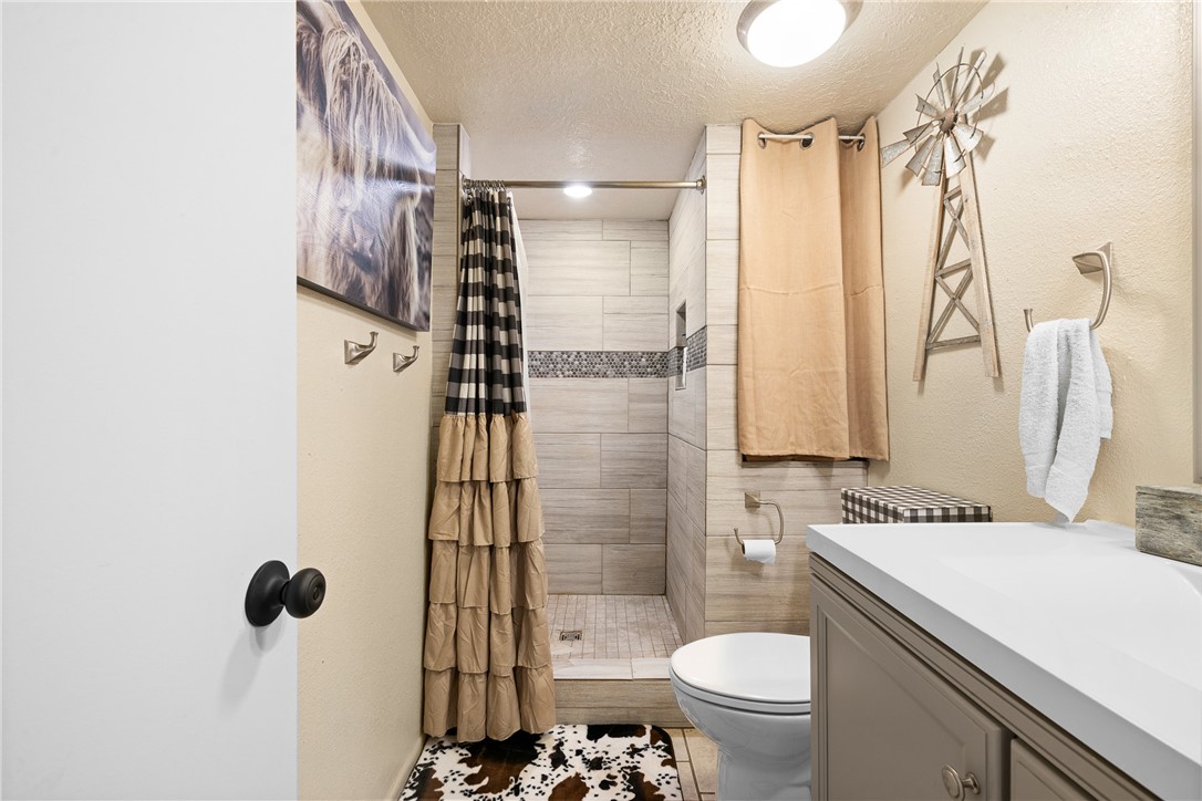 2098 Cedar Creek Road Hearne, TX 77859 - Photo 9 of 18 a bathroom with a sink toilet and shower