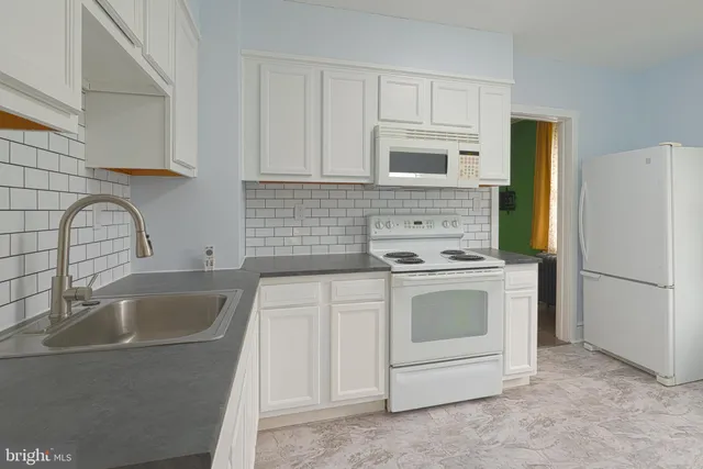 a view of a storage & utility room with a sink