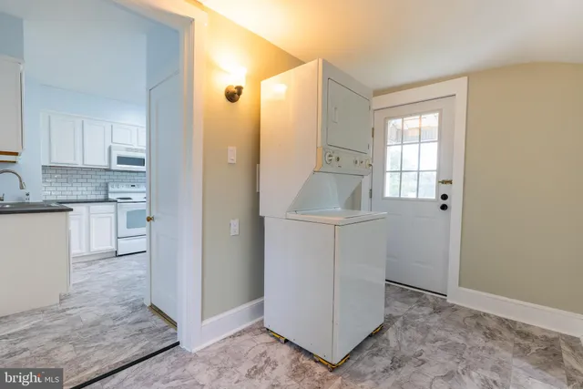 a view of a livingroom with wooden floor and staircase