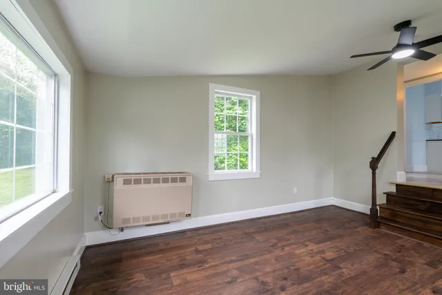 a view of room with stairs and wooden floor