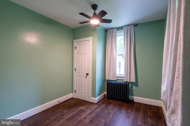 a view of a room with wooden floor and a window