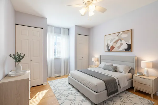 an empty room with wooden floor and closet area