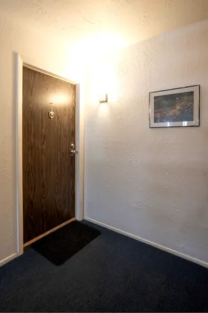 a view of a swimming pool with a yard and large trees