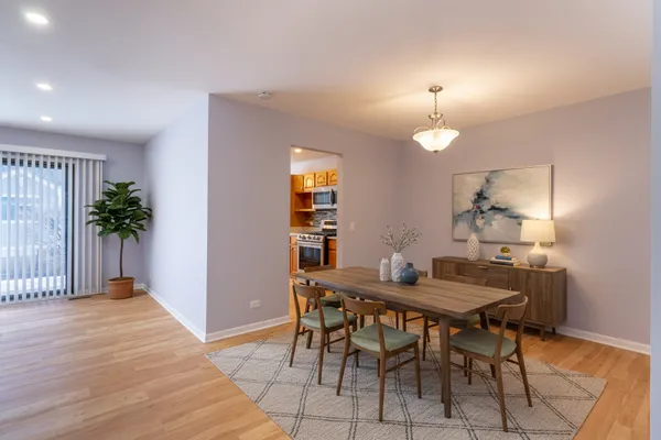 a kitchen with stainless steel appliances granite countertop a sink and a stove top oven with wooden floor