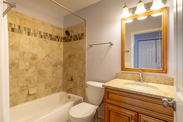 a bedroom with a bed chandelier and a window