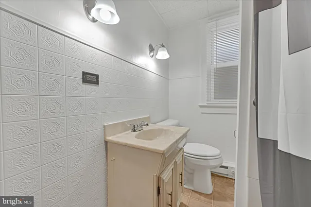 a bathroom with a sink toilet and vanity