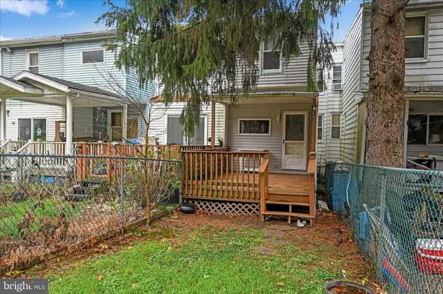 a view of a house with a yard and sitting area