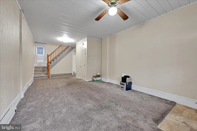 an empty room with stairs and mirrors