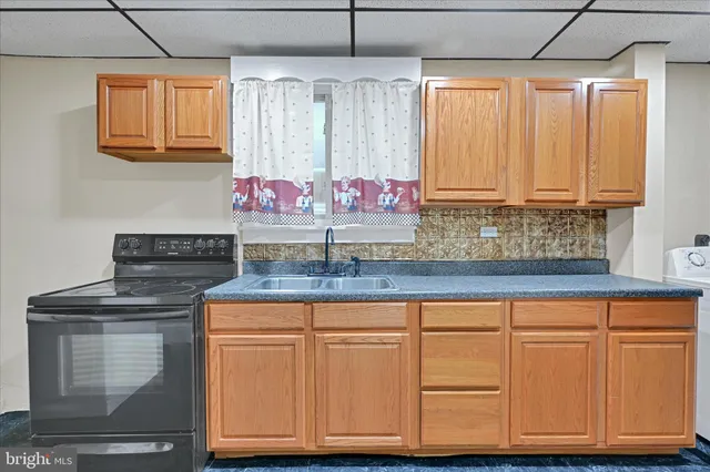 a kitchen with granite countertop cabinets and white appliances