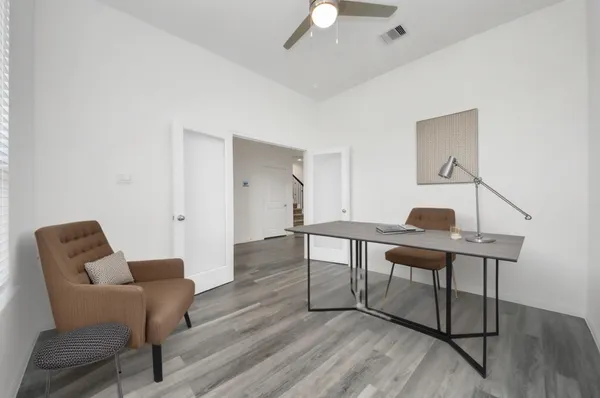 a work room with furniture and wooden floor