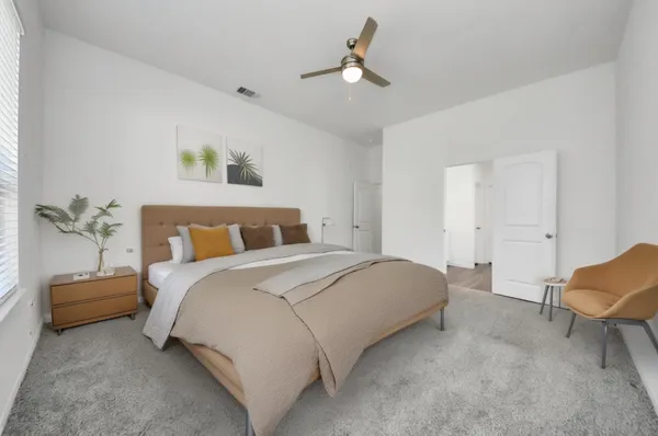 a bedroom with a bed and a chair