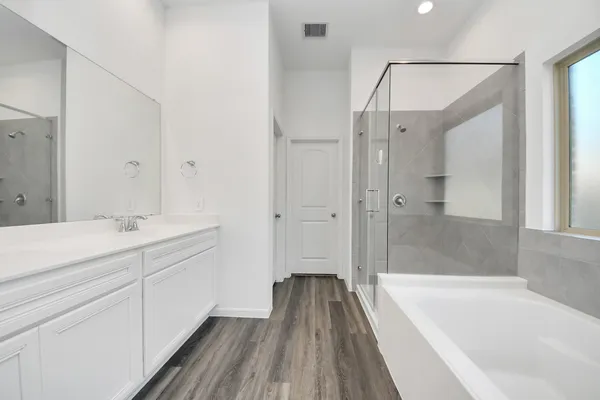 a bathroom with a bathtub and a sink