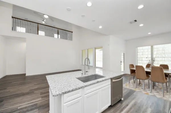 a kitchen with granite countertop cabinets a sink and appliances