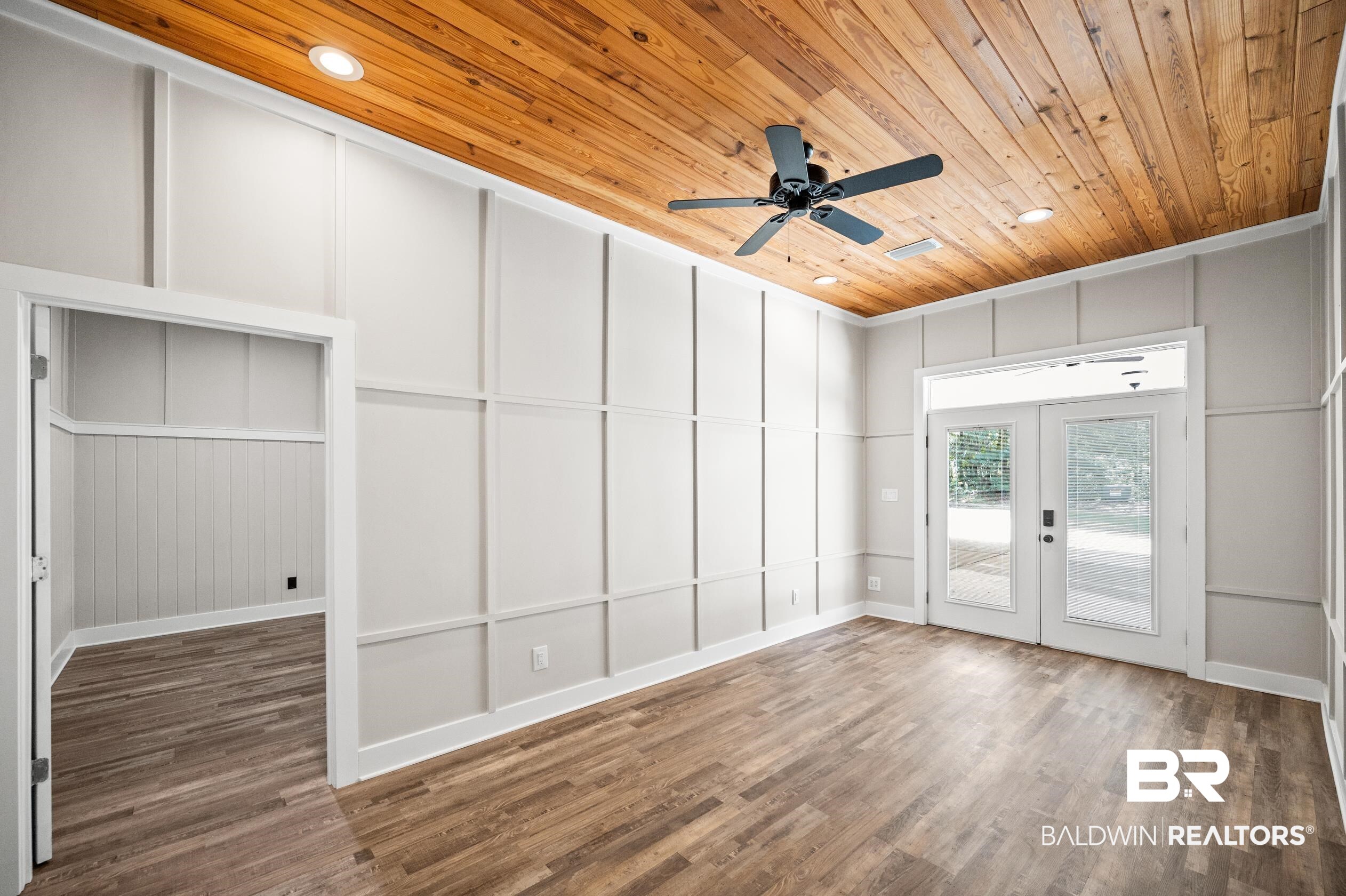15031 Timber Ridge Drive Loxley, AL 36551 - Photo 29 of 43 Spare room featuring ceiling fan, hardwood / wood-style flooring, french doors, and wooden ceiling