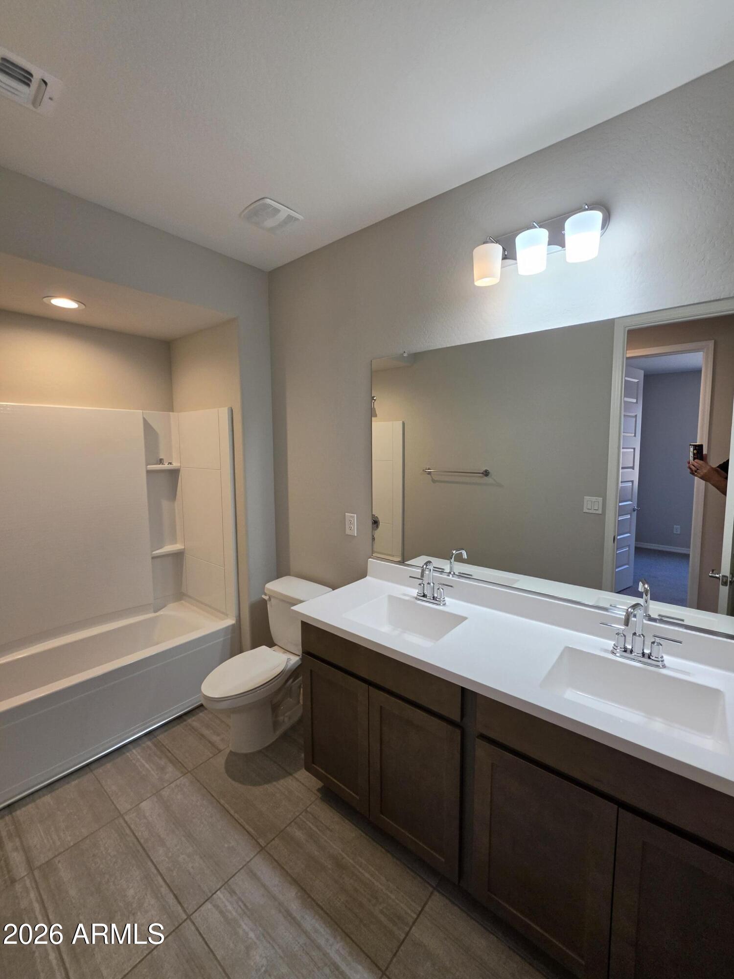 7128 West Coles Road Laveen, AZ 85339 - Photo 32 of 38 a bathroom with a sink double vanity granite tub and a mirror