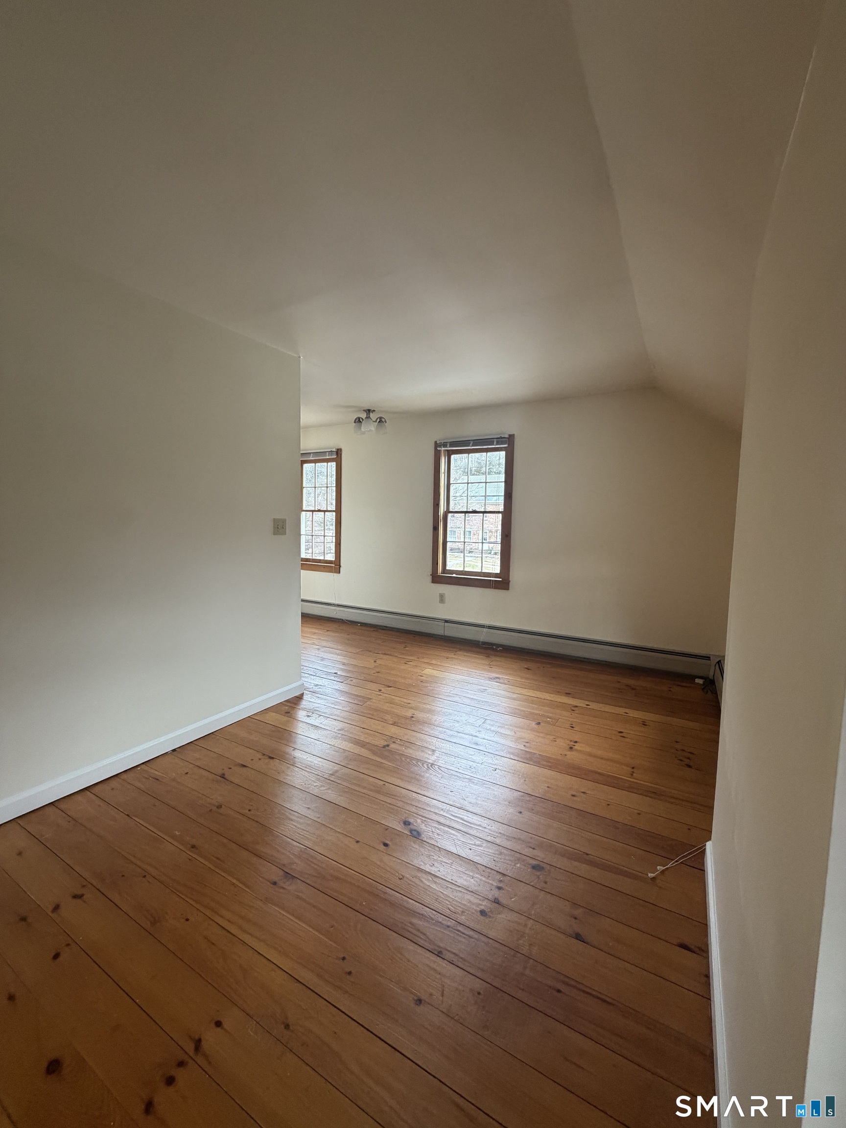 43 Dublin Road Canaan, CT 06031 - Photo 2 of 11 an empty room with wooden floor and windows