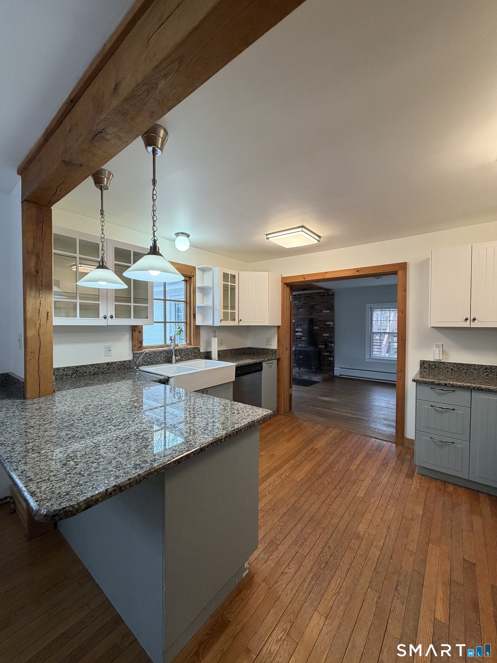43 Dublin Road Canaan, CT 06031 - Photo 4 of 11 a kitchen with stainless steel appliances granite countertop a sink a stove counter space and wooden floor
