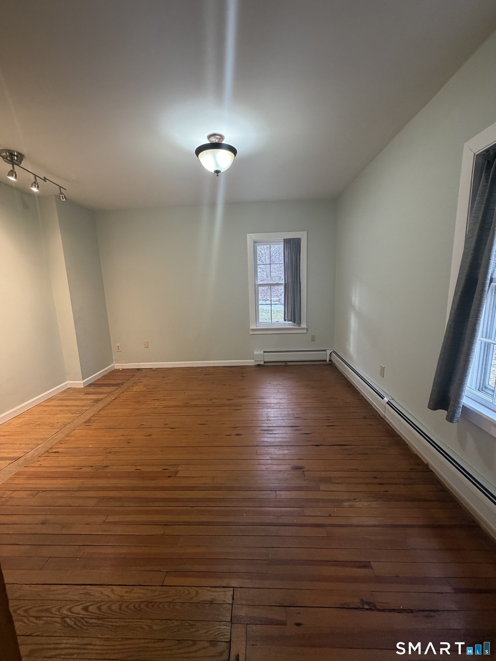 43 Dublin Road Canaan, CT 06031 - Photo 5 of 11 an empty room with wooden floor and windows
