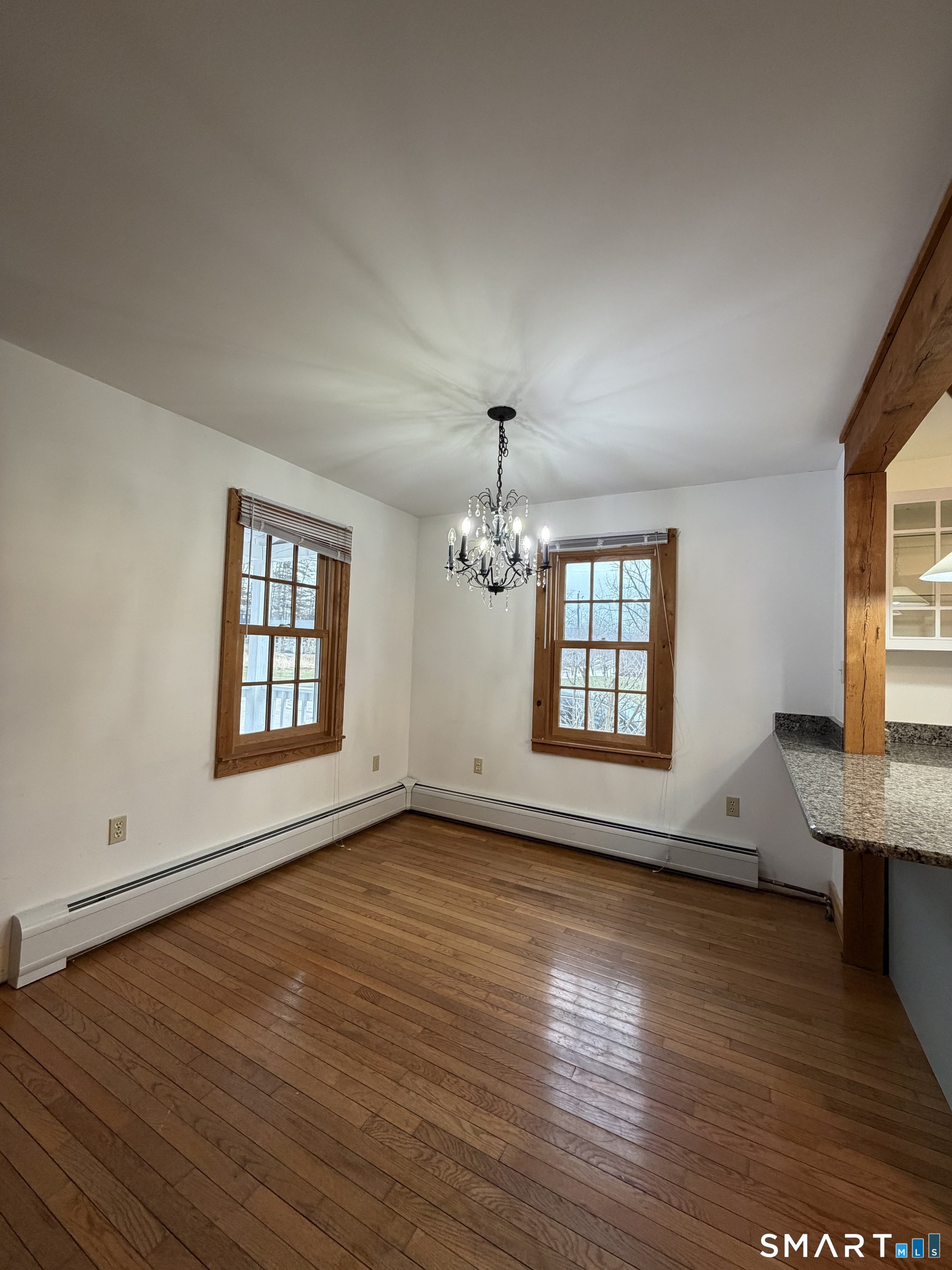43 Dublin Road Canaan, CT 06031 - Photo 5 of 11 an empty room with wooden floor chandelier and windows
