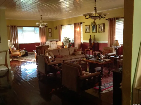 a living room with lots of furniture and a chandelier