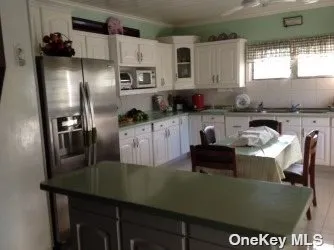 a kitchen with kitchen island a stove a sink and a refrigerator