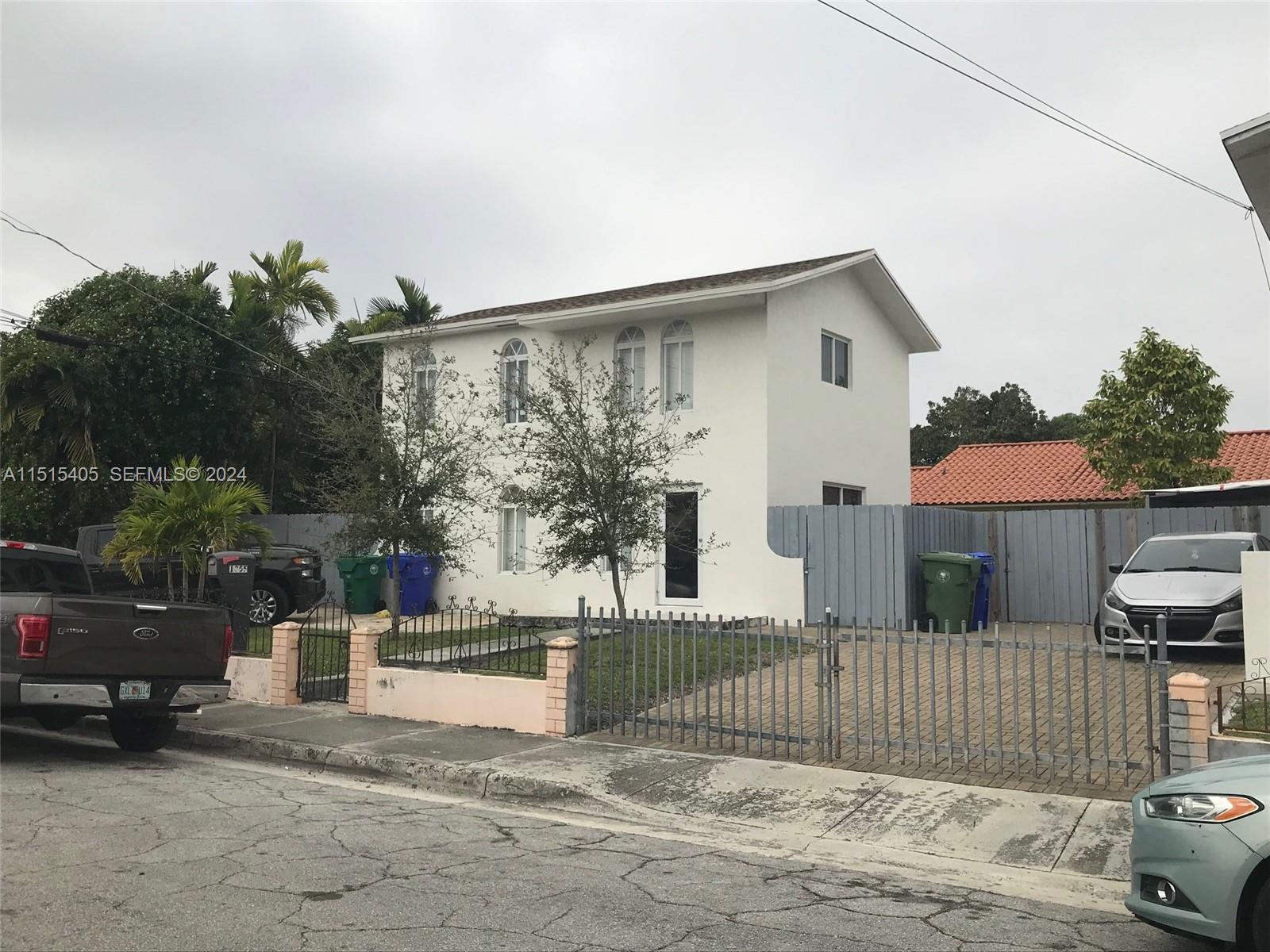 1355 Southwest 12th Street Miami, FL 33135 - Photo 16 of 18 a view of a house with a small yard and plants