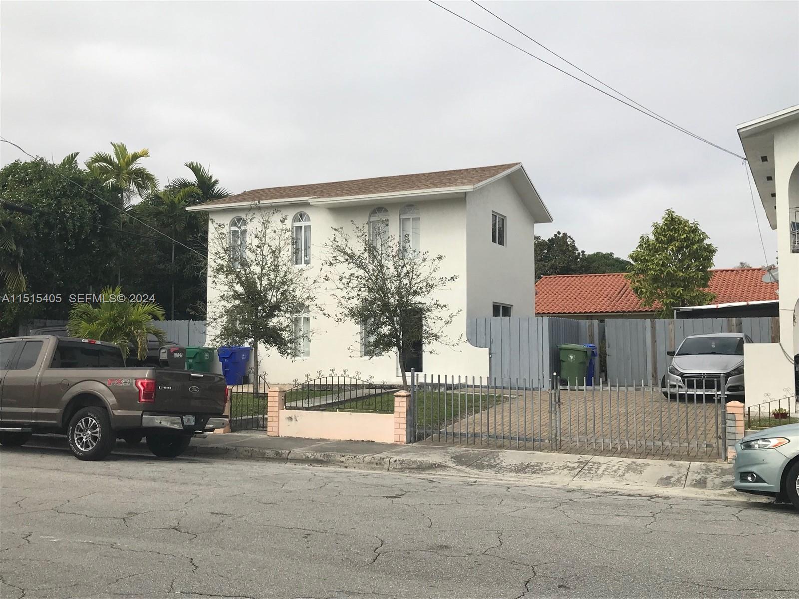 1355 Southwest 12th Street Miami, FL 33135 - Photo 7 of 18 a car parked in front of a house