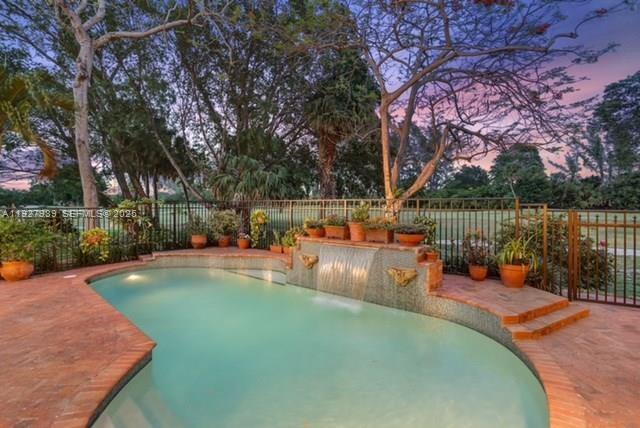 7820 Northwest 83rd Street Tamarac, FL 33321 - Photo 3 of 3 a view of a swimming pool with lounge chairs in front of house