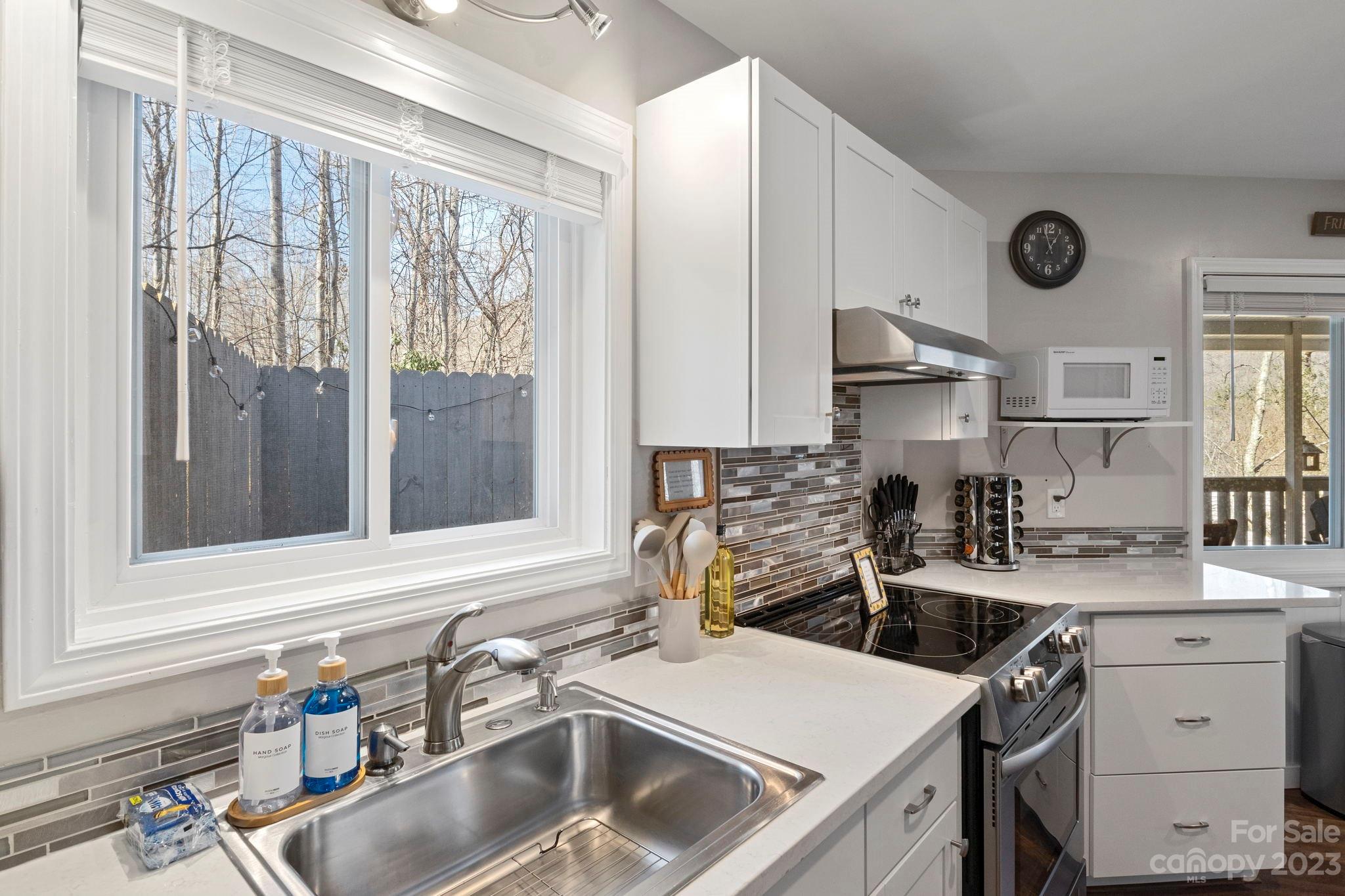 180 Hemlock Loop Maggie Valley, NC 28751 - Photo 11 of 28 a kitchen that has a sink and a stove in it
