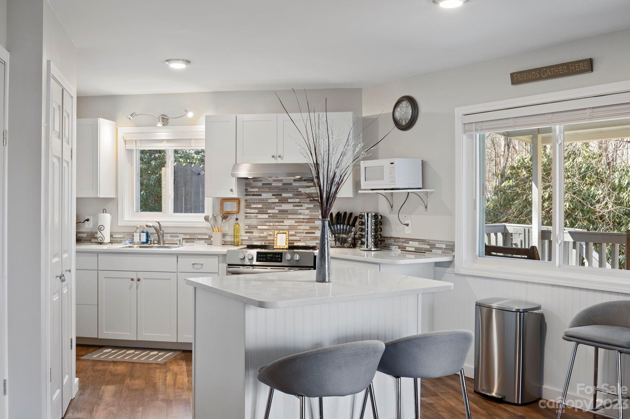 180 Hemlock Loop Maggie Valley, NC 28751 - Photo 14 of 28 a kitchen with stainless steel appliances granite countertop a stove a sink and a refrigerator