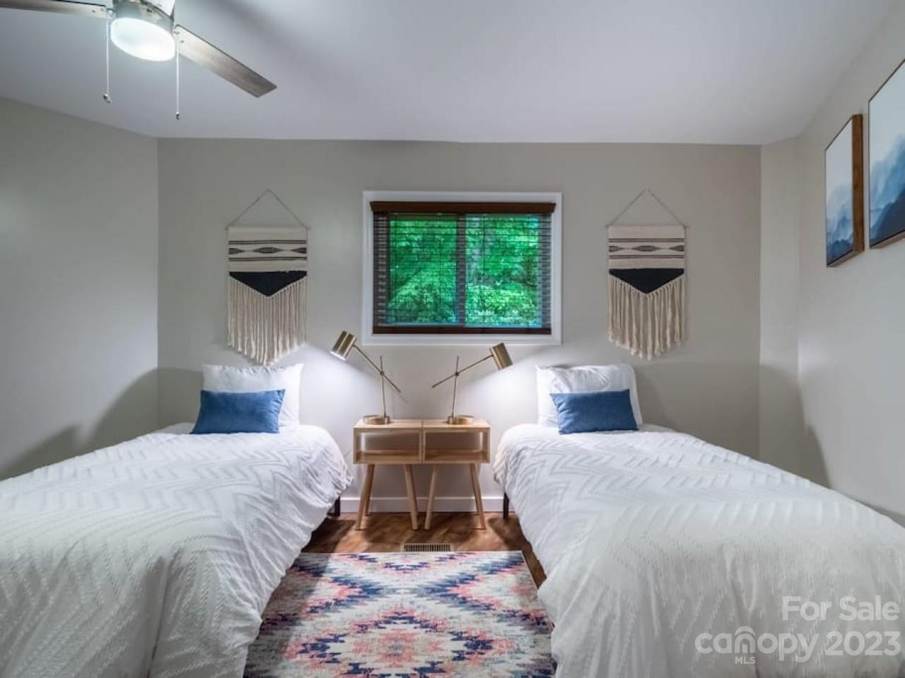 180 Hemlock Loop Maggie Valley, NC 28751 - Photo 15 of 28 a bedroom with a large bed and a window