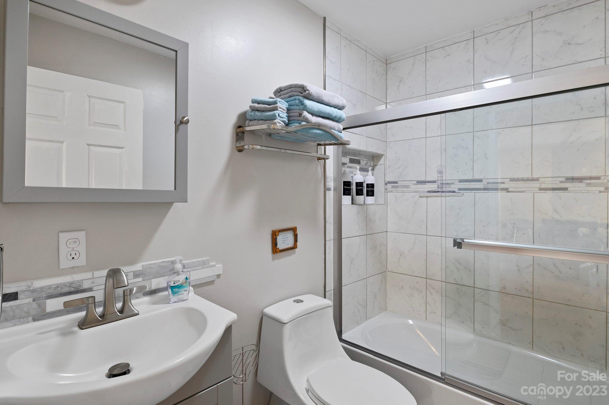 180 Hemlock Loop Maggie Valley, NC 28751 - Photo 16 of 28 a bathroom with a sink toilet and shower
