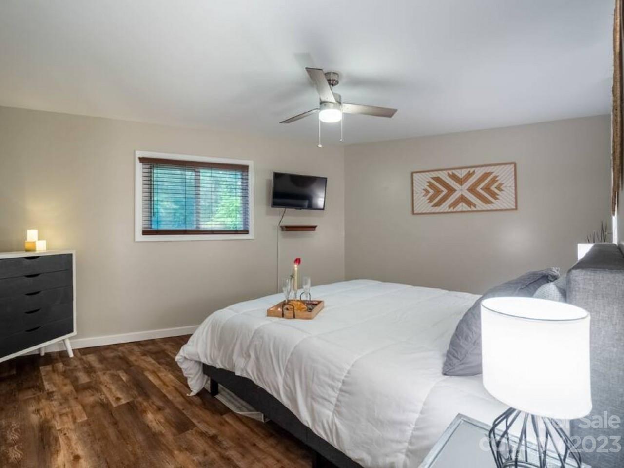 180 Hemlock Loop Maggie Valley, NC 28751 - Photo 20 of 28 a bedroom with a bed and a painting on the wall