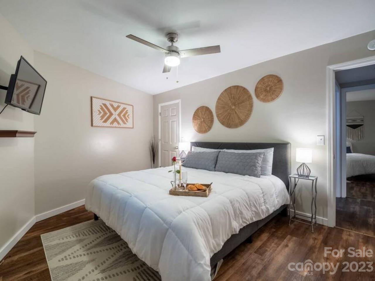180 Hemlock Loop Maggie Valley, NC 28751 - Photo 21 of 28 a bedroom with a bed and a lamp