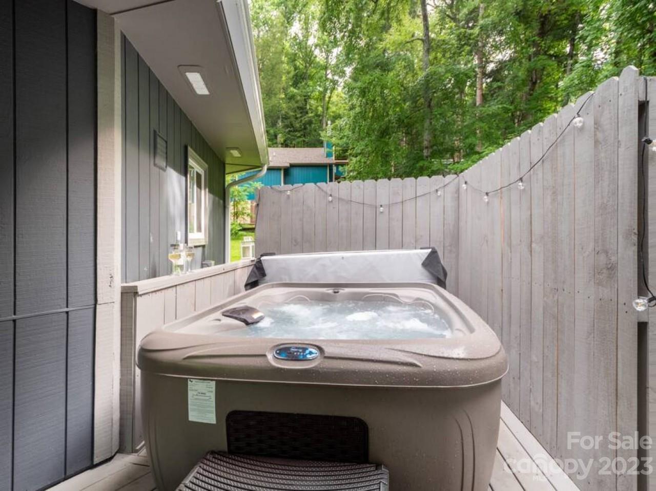180 Hemlock Loop Maggie Valley, NC 28751 - Photo 24 of 28 a view of barbeque grill with chair and wooden fence