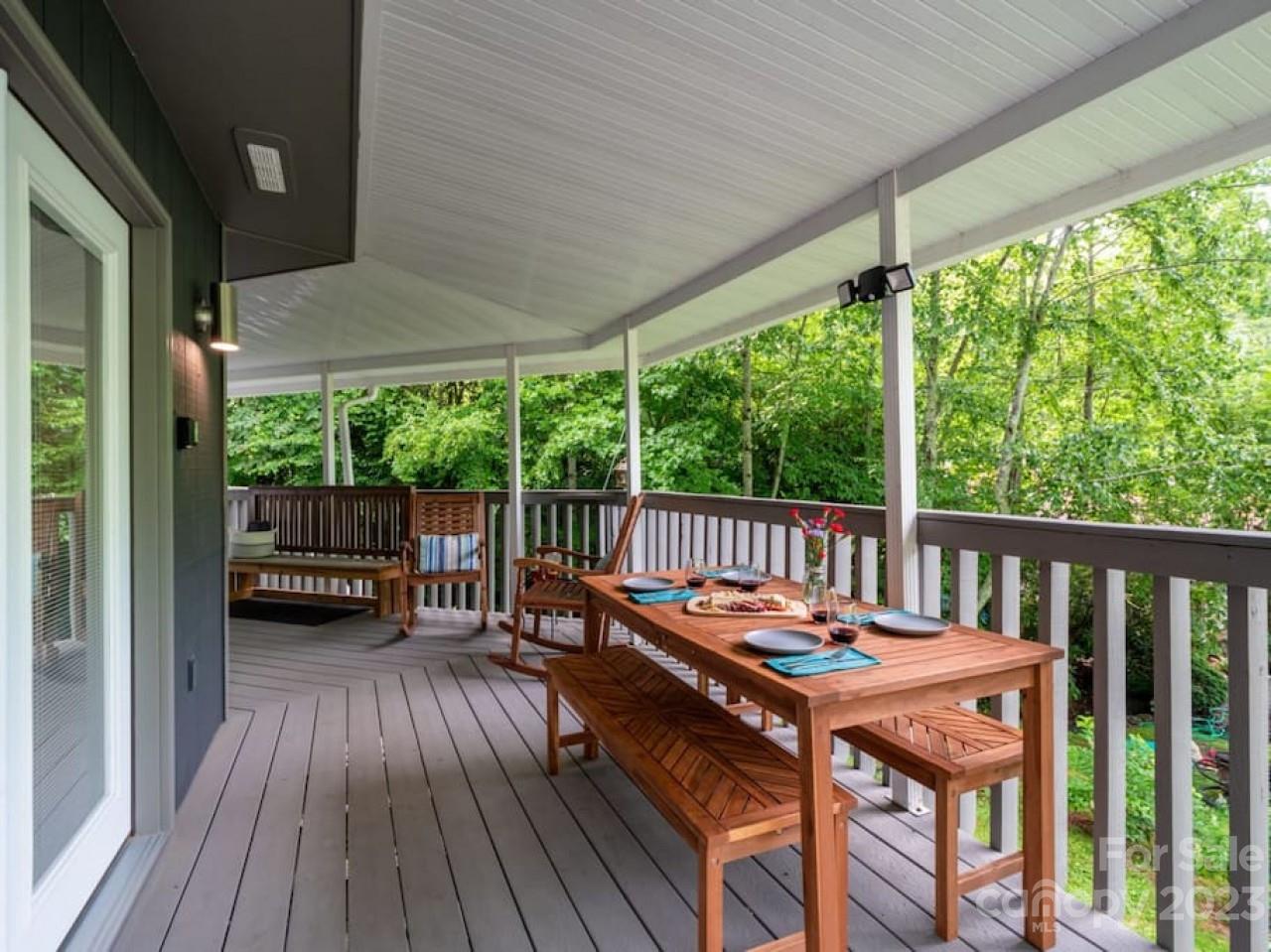 180 Hemlock Loop Maggie Valley, NC 28751 - Photo 26 of 28 a balcony with furniture and wooden floor