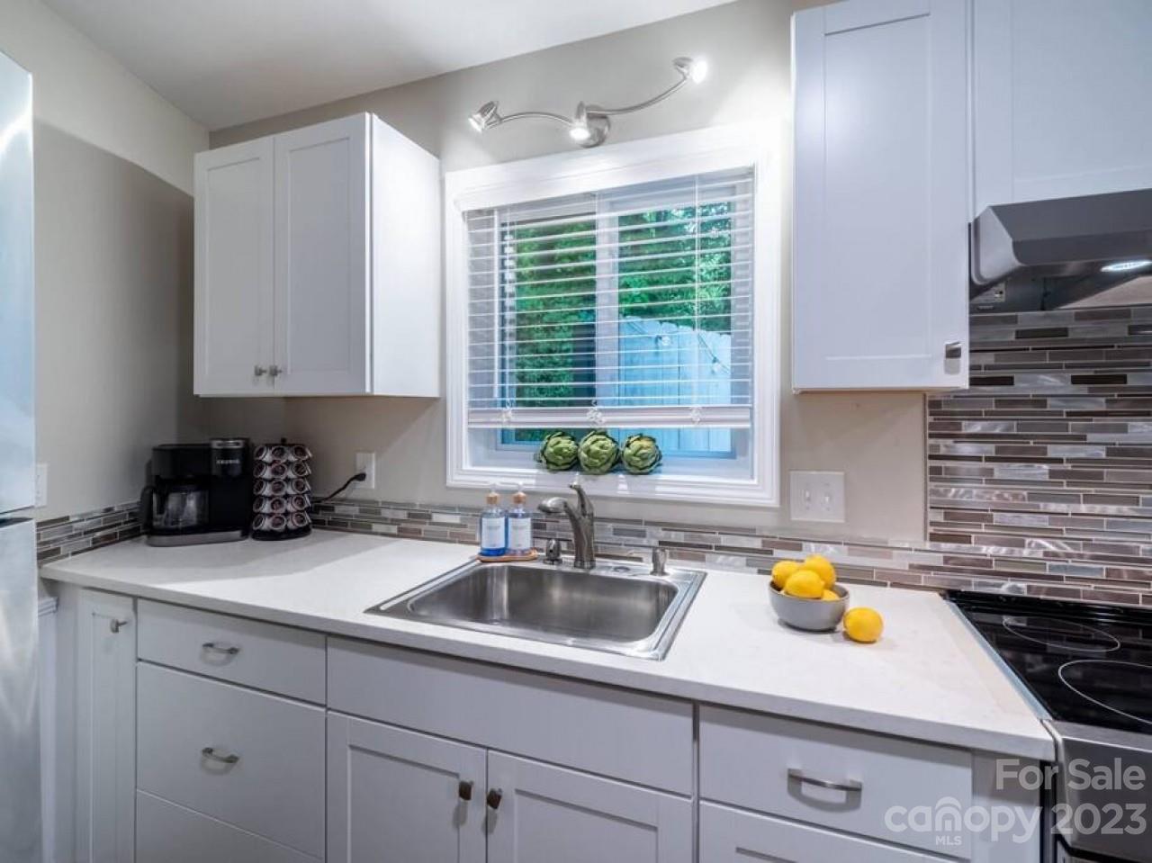 180 Hemlock Loop Maggie Valley, NC 28751 - Photo 10 of 28 a kitchen with stainless steel appliances a sink a stove and cabinets