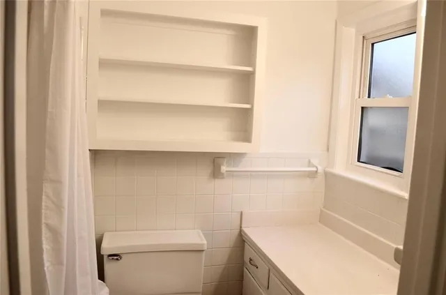 a bathroom with a toilet and a sink