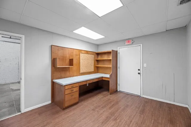 a room with wooden floor and furniture