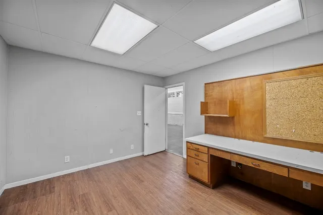 a room with wooden floor and furniture