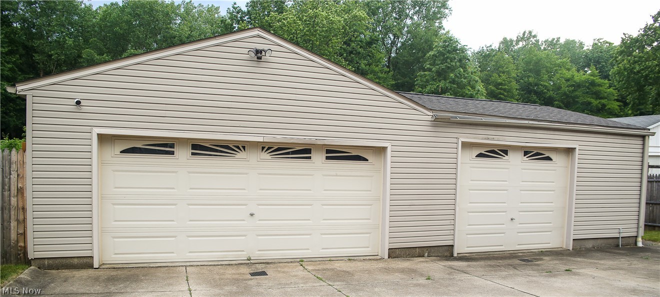 1258 Vane Avenue Akron, OH 44310 - Photo 2 of 12 Attached garage featuring light-colored siding and two garage doors