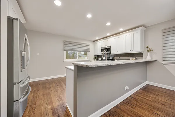 a kitchen with a sink stainless steel appliances and cabinets