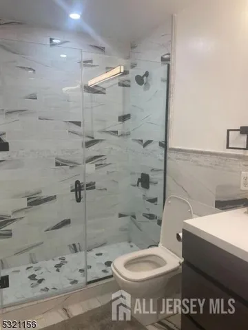 a bathroom with a toilet and a shower