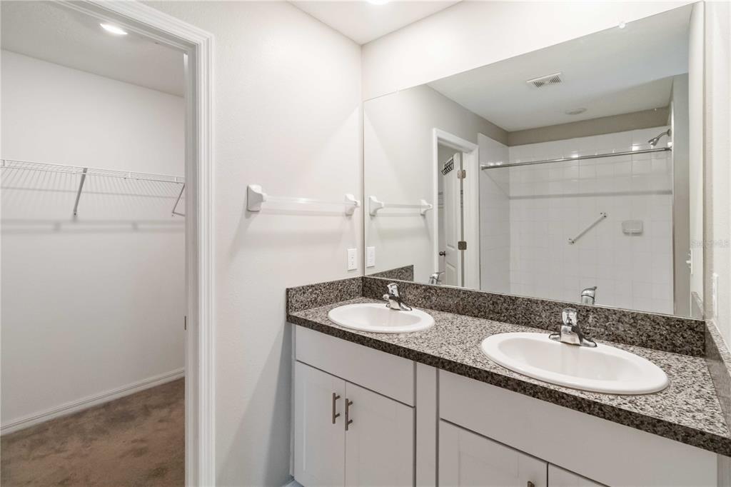 1777 Fred Ives Street Ruskin, FL 33570 - Photo 16 of 35 a bathroom with a granite countertop sink and a mirror