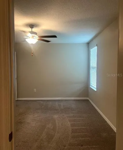 a bathroom with a granite countertop sink a toilet a mirror and bathtub