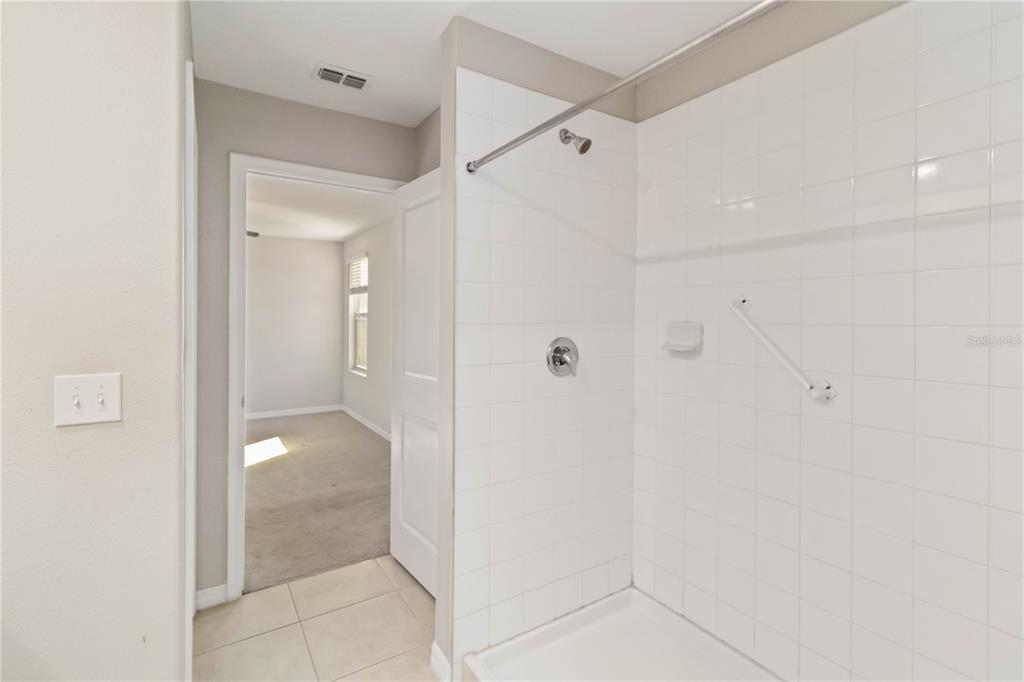1777 Fred Ives Street Ruskin, FL 33570 - Photo 19 of 35 a bathroom with a glass shower door
