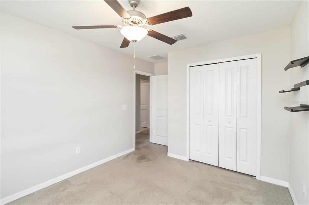 1777 Fred Ives Street Ruskin, FL 33570 - Photo 24 of 35 an empty room with a ceiling fan and a window